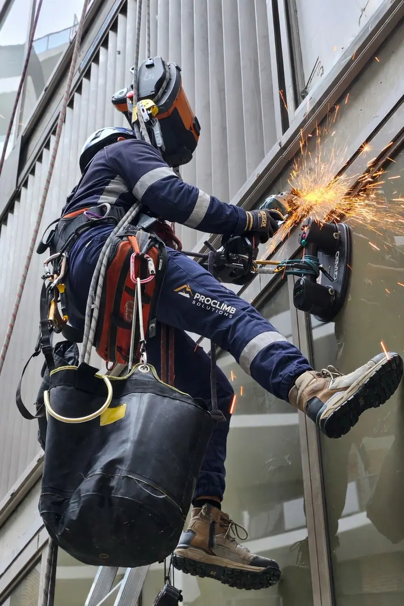 ProClimb technician grinding on a building facade