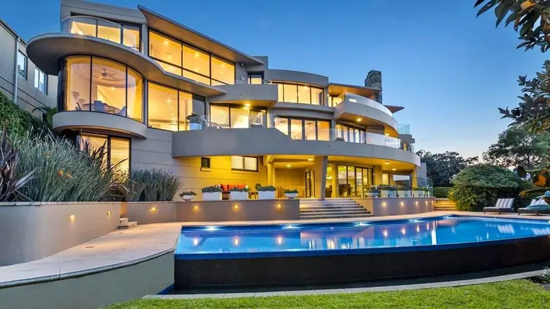 Luxury home with infinity pool at dusk